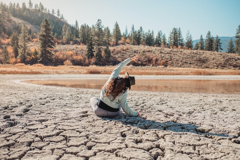 Woman practicing yoga at sunset